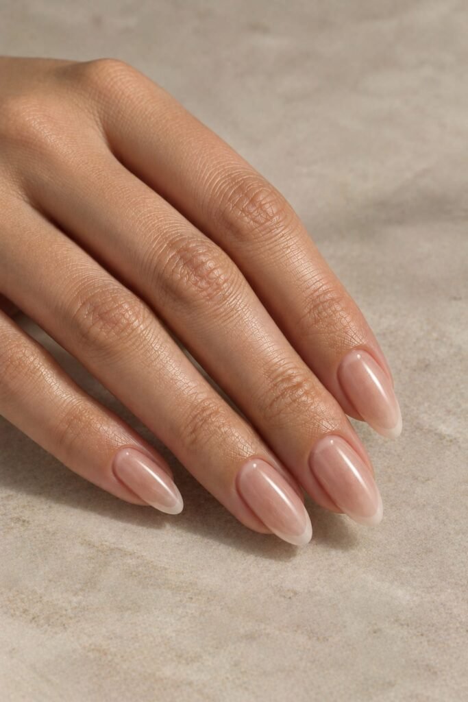 Almond foggy French nails with creamy tips and subtle champagne chrome