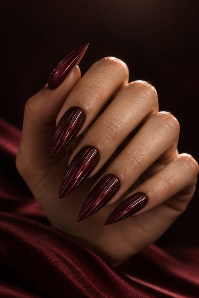 Cherry cola red stiletto ribbed glass nails with magnetic shimmer