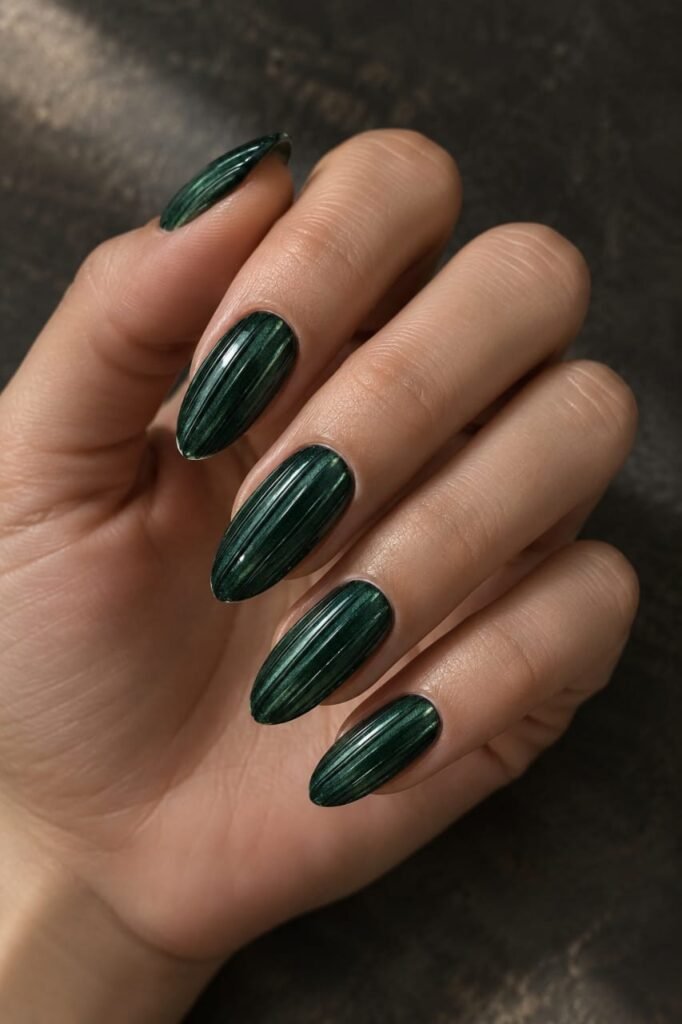 Deep emerald green ribbed glass nails with glossy raised vertical texture