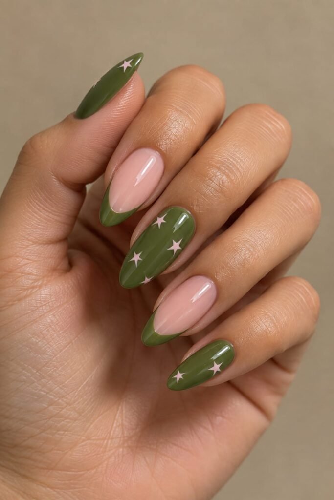 Deep green and blush pink almond nails with tiny star details