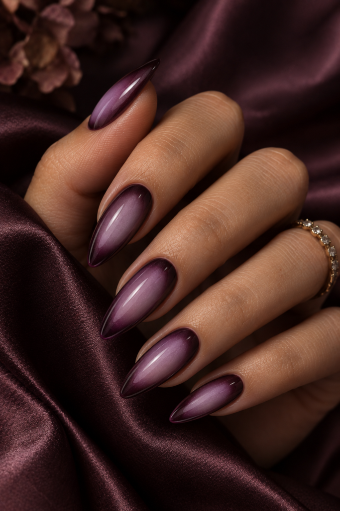 Long almond nails with a glossy lavender-to-deep-plum aura nail design.