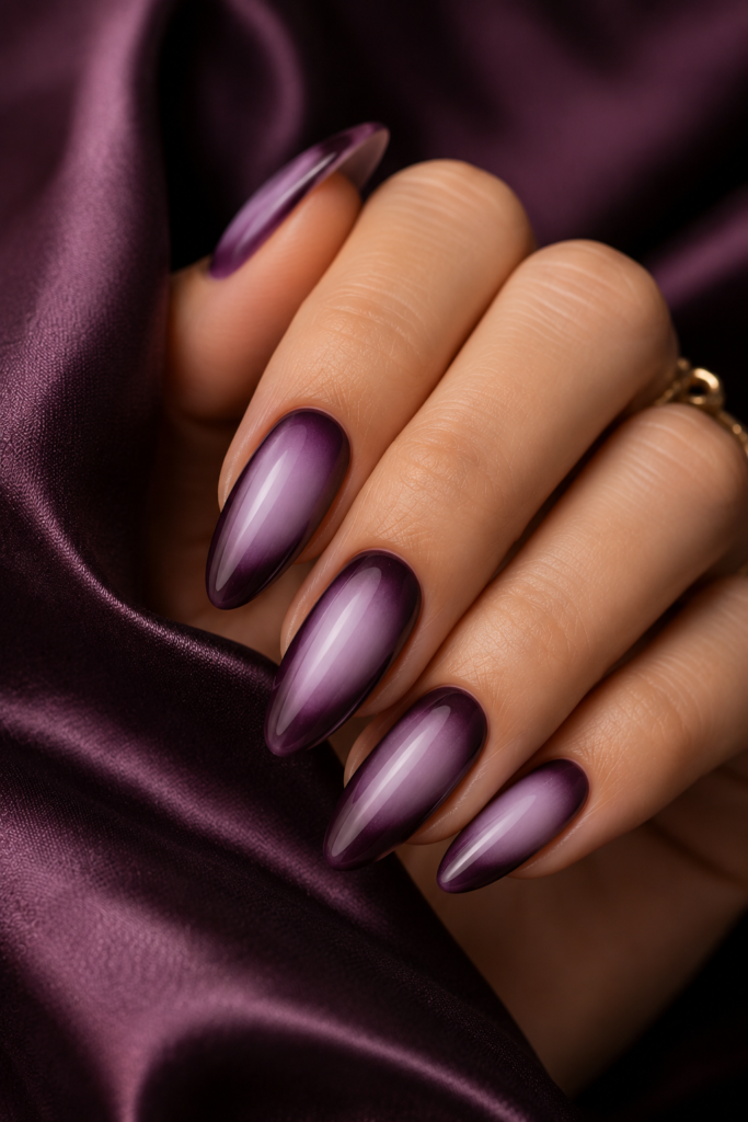 Long almond nails with a glossy lavender-to-deep-plum aura design.