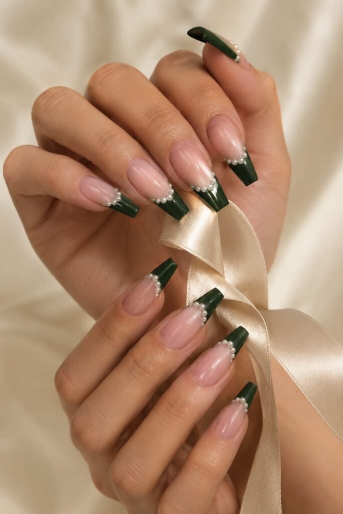 Long coffin nails with deep emerald French tips decorated with tiny pearl accents.