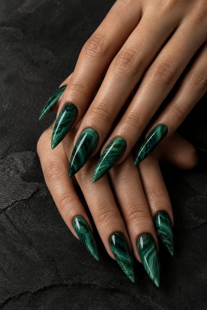 Long stiletto emerald marble nails with deep green malachite-inspired bands