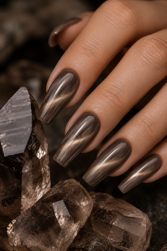 Long tapered square nails with smoky taupe cat-eye polish and luminous magnetic dimension.