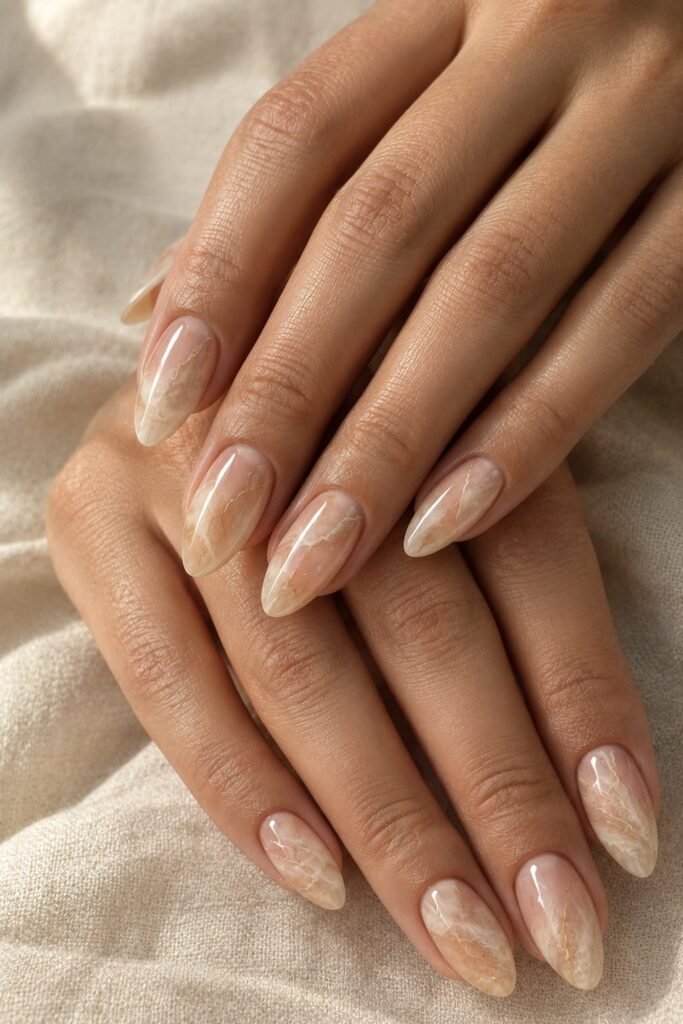  Medium almond peach marble nails with soft ivory and sandy cloud-like layers