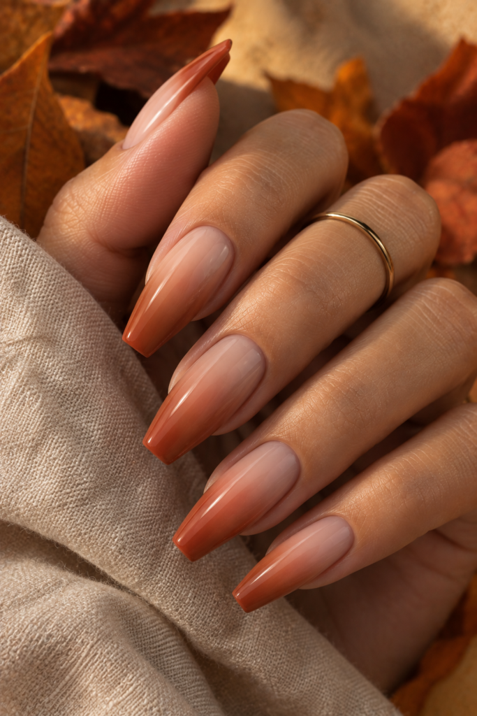Medium coffin nails with a warm nude-to-terracotta ombré gradient.