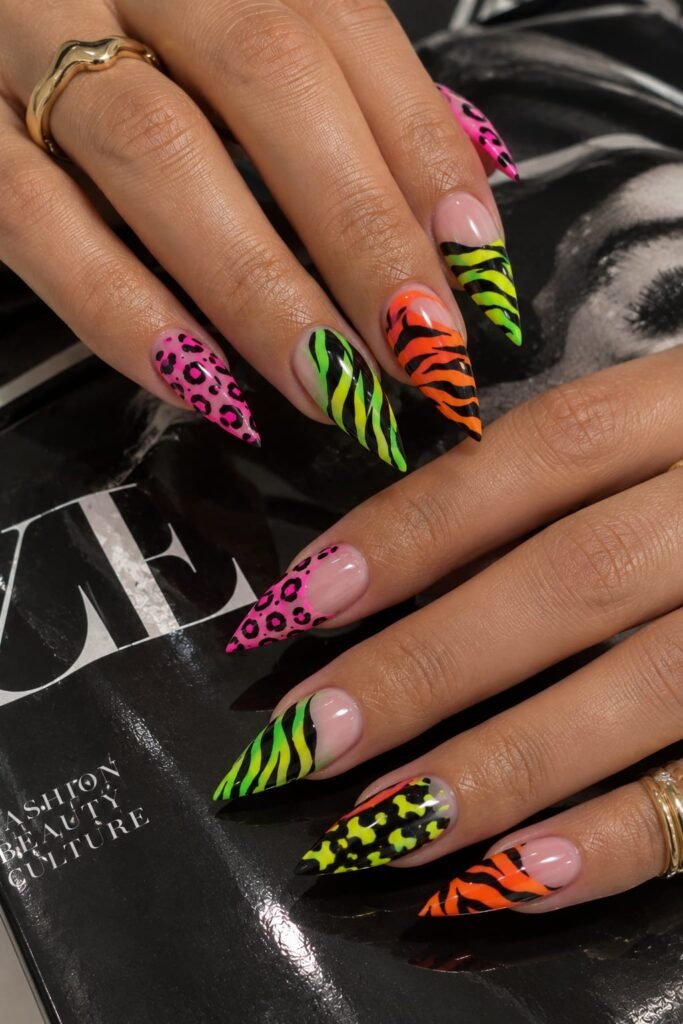 Multicolor neon animal print nails with pink, green, orange, and yellow patterns.