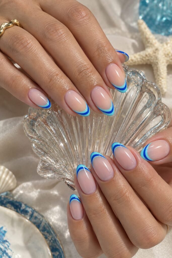 Neon blue double French nails with electric blue and aqua tips.