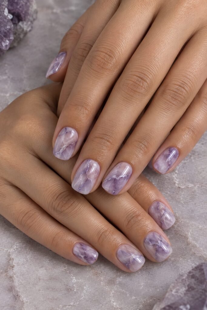 Short squoval lavender marble nails with cloudy white and amethyst-purple veins