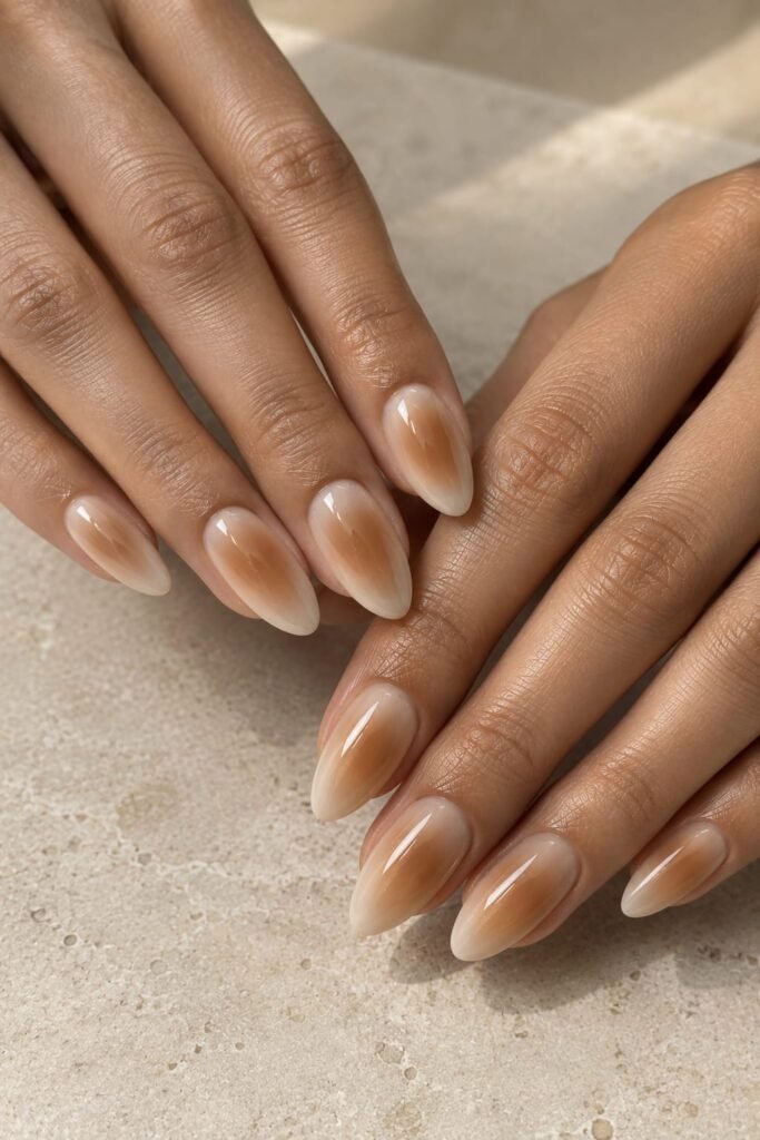 Soft beige almond aura nails with a warm caramel center