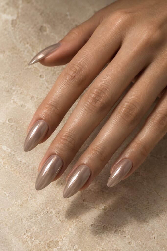 Taupe beige almond nails with a subtle chrome metallic glow