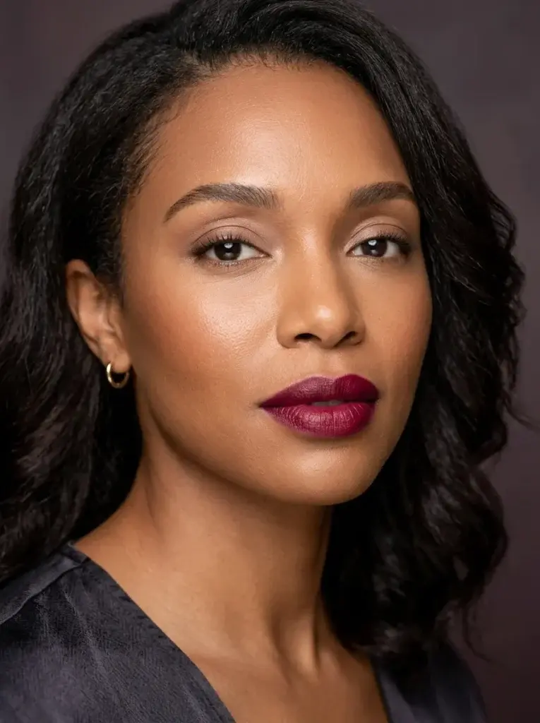 Berry-wine lipstick with softly blurred edges, minimal eye makeup, and luminous natural skin.